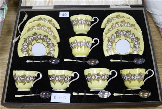 A boxed Aynsley teaset with enamelled silver spoons